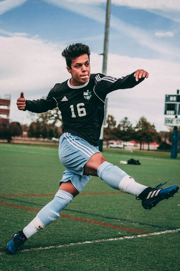 A footballer mid-kick on a turf